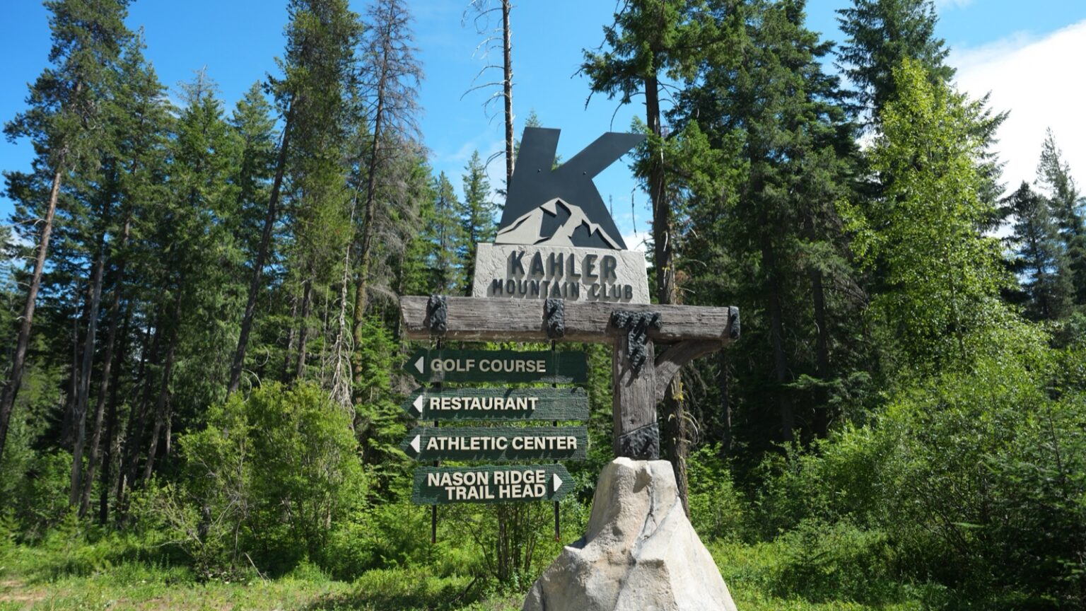 The Kahler Mountain Club entrance sign among the pines.