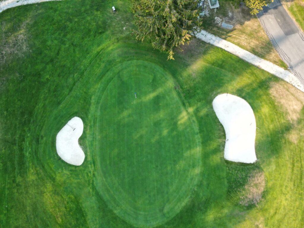 Aerial view of hole 7 at Kahler Mountain Club, a par 4 of 306 yards from the blue tees.